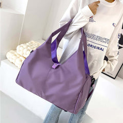 Womens Yoga Bag in purple color being held by a person, featuring shoulder straps and a stylish design.